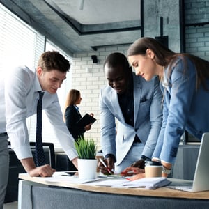 Image of 3 coworkers reviewing paperwork
