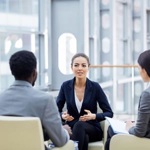 Professionals sitting in an atrium talking