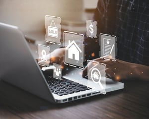 A person using a laptop with digital real estate icons overlaid on the screen, representing property listings, transactions, and technology-enabled customer service in real estate education or operations.