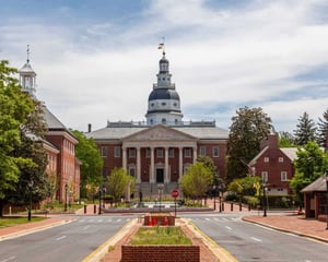 A view of a historic government building with a domed roof and columned entrance, representing a municipal facility supported by a modern, mobile-responsive SharePoint solution.