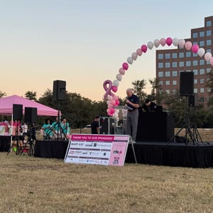 Stage with pink and white balloons at the Mary Kay 5K run for charity