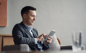 Person sitting in a chair using a tablet